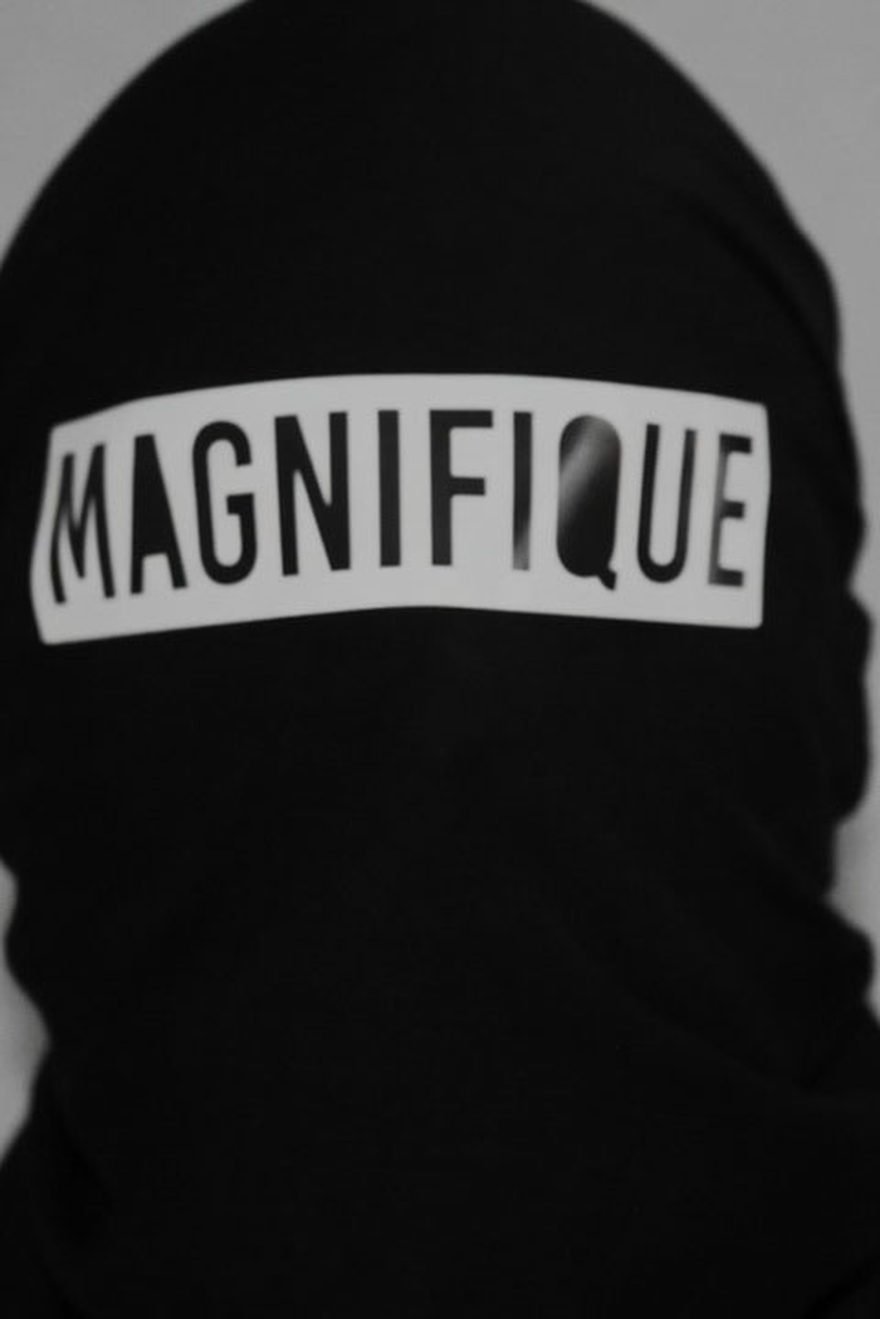 Magnifiqué streetwear concept: a figure in a black balaclava with the wordmark across the eyes